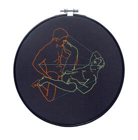 Embroidery in neon orange and yellow displayed in black embroidery hoop
